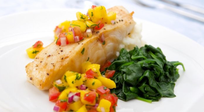 Healthy fish dish with fruits and vegetables