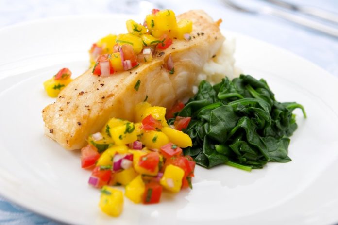 Healthy fish dish with fruits and vegetables