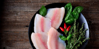 Raw Tilapia fillets with herbs and spices