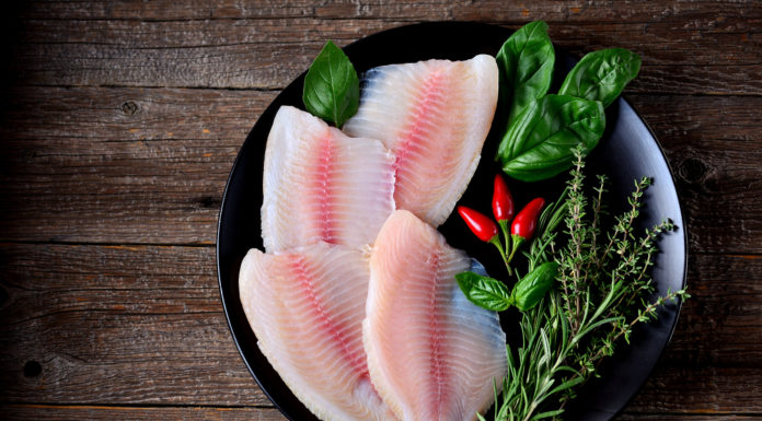 Raw Tilapia fillets with herbs and spices