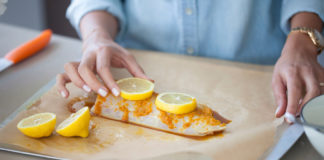 Woman preparing fish dinner