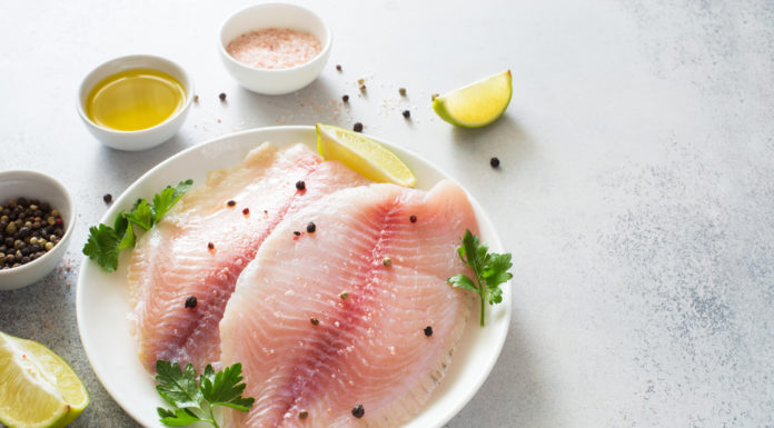 Raw Tilapia fillets seasoned with salt and pepper