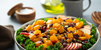 Salad with kale, roasted squash, pumpkin seeds and apples