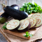 Sliced eggplant on wooden cutting board