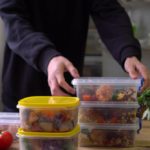 Man organizing meal prep containers