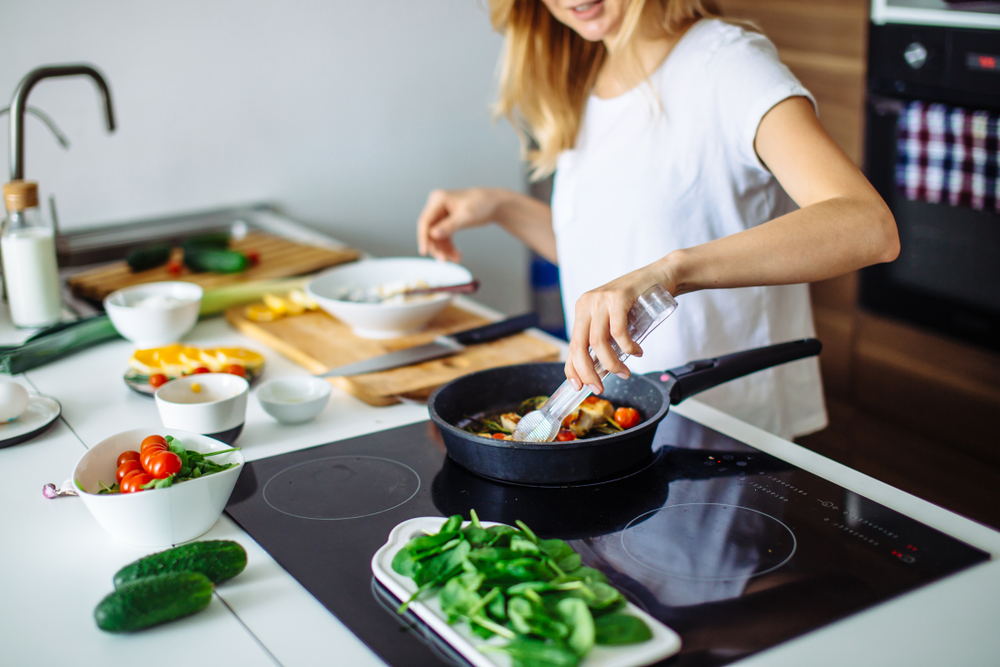 Young woman cooking in the kitchen