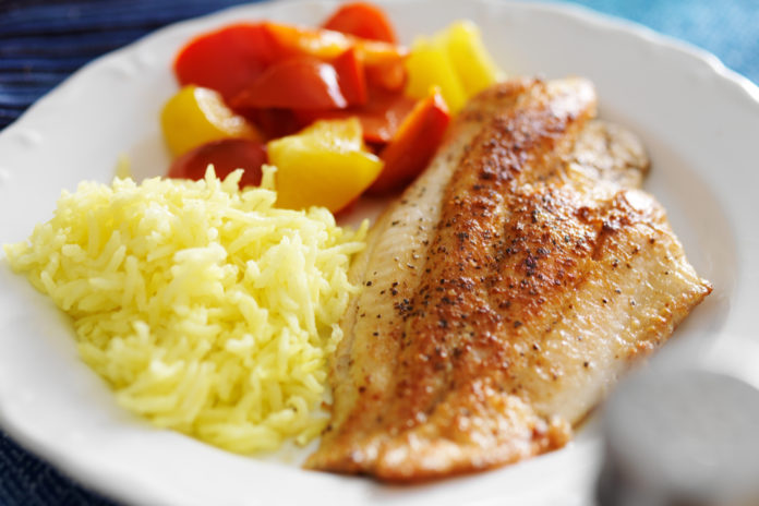 Fried tilapia fillet with rice and vegetables