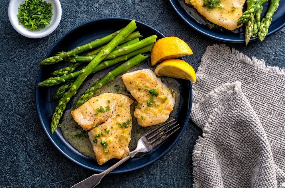 Poached fish with lemon and asparagus