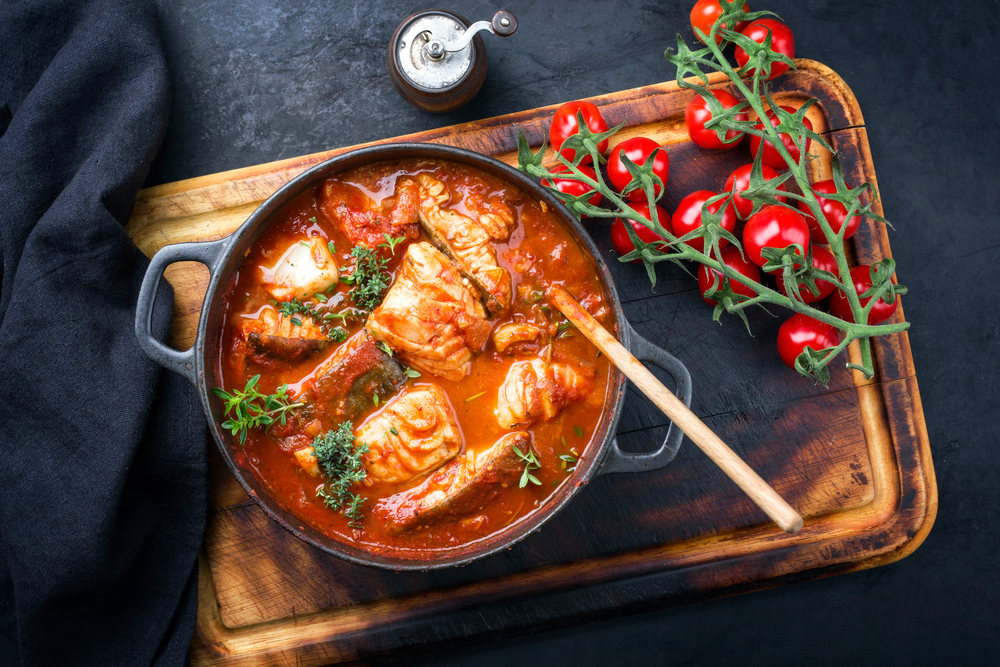 Fish simmered in tomato and herb sauce