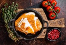 Roasted Tilapia fillet in a skillet with breadcrumbs