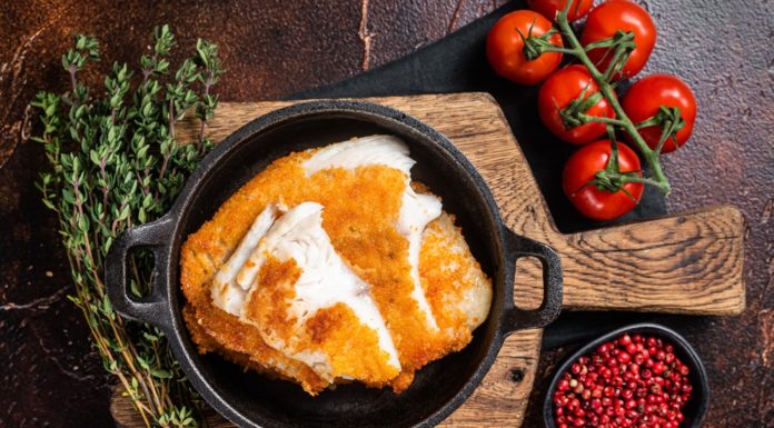 Roasted Tilapia fillet in a skillet with breadcrumbs